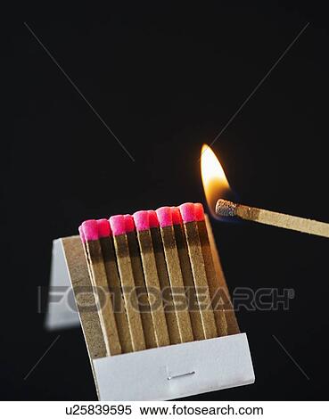 Stock Photography - Close up of matches with one burning. Fotosearch