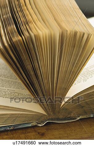 Stock Image - Close up of pages in antique open book. Fotosearch