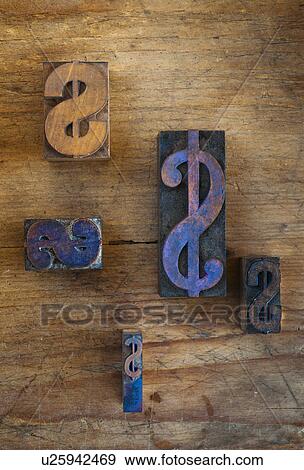 Stock Photo - Close up of printing blocks with dollar sign on wood. Fotosearch