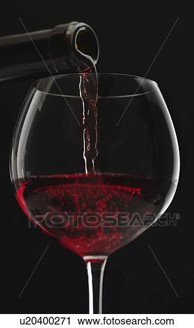 Close up of red wine being poured into wine glass View Large Photo Image Stock Image - Close up of red wine being poured into wine glass. Fotosearch