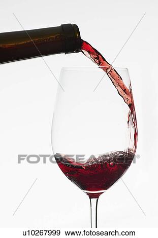 Close up of red wine being poured into wine glass View Large Photo Image Stock Photo - Close up of red wine being poured into wine glass. Fotosearch
