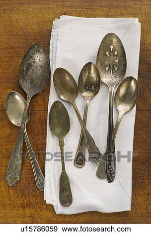 Stock Photo - Close up of rusty silver spoons and napkin. Fotosearch