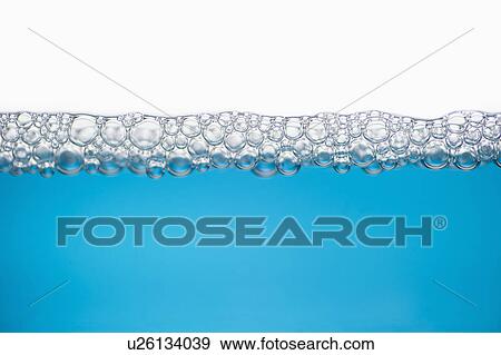 Stock Photo - Close up of soap bubbles on water surface. Fotosearch