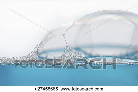 Stock Photography - Close up of soap bubbles on water surface. Fotosearch