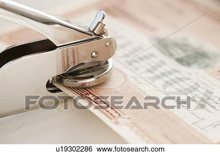 Stock Photograph - Close up of stamper making seal on stock share. Fotosearch