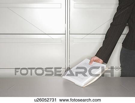 Close up of woman's hand in office holding documents View Large Photo Image Stock Image - Close up of woman's hand in office holding documents. Fotosearch
