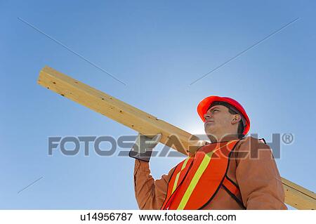 Construction worker carrying planks View Large Photo Image Stock Photo - Construction worker carrying planks. Fotosearch
