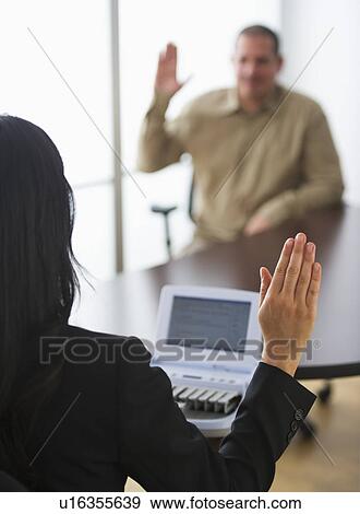 Stock Photo - Court stenographer and client raising hands. Fotosearch