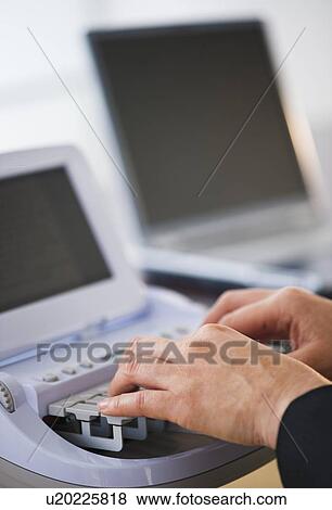 Stock Photo - Court stenographer using stenograph machine. Fotosearch