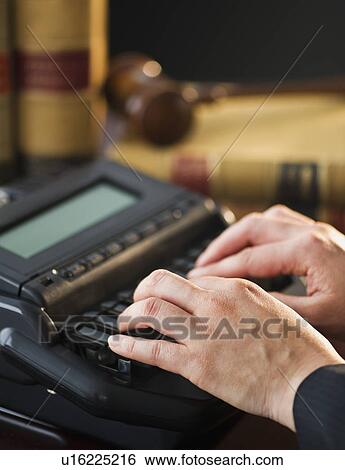Stock Photograph - Court stenographer using stenograph machine. Fotosearch
