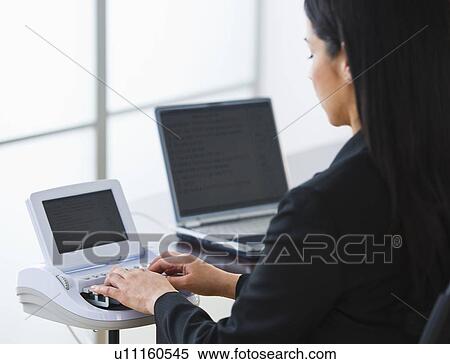 Stock Photography - Court stenographer using stenograph machine. Fotosearch