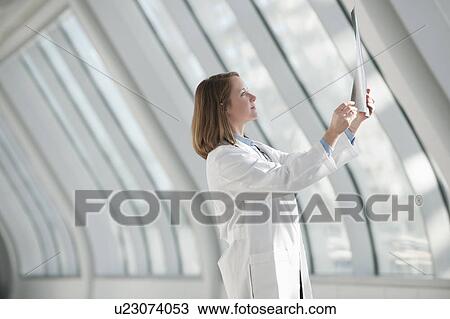 Stock Image - Doctor examining x-ray. Fotosearch