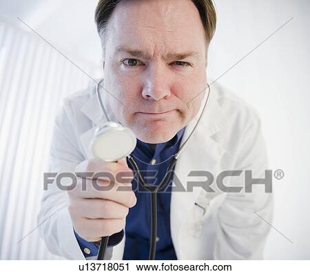 Stock Image - Doctor holding stethoscope. Fotosearch