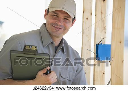 Picture - Electrician working at construction site. Fotosearch