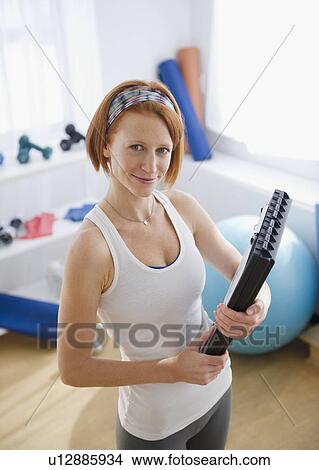 Exercise trainer holding clipboard View Large Photo Image Picture - Exercise trainer holding clipboard. Fotosearch