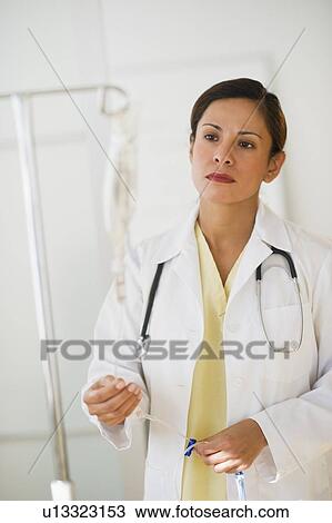 Stock Image - Female doctor with IV drip. Fotosearch