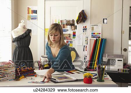 Female fashion designer working in office View Large Photo Image Stock Photo - Female fashion designer working in office. Fotosearch