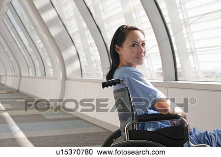 Stock Image - Female patient in wheelchair. Fotosearch