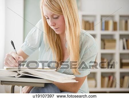 Stock Photo - Female student doing homework. Fotosearch