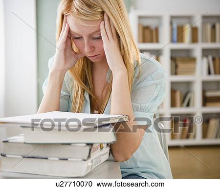 Stock Image - Female student having headache. Fotosearch
