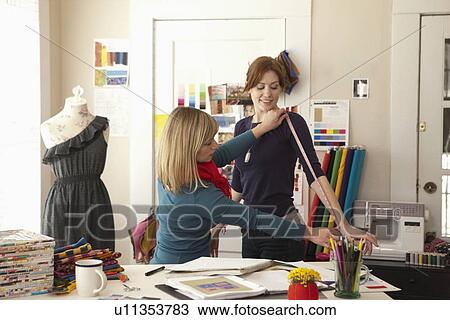 Female tailor taking measure from client View Large Photo Image Stock Image - Female tailor taking measure from client. Fotosearch