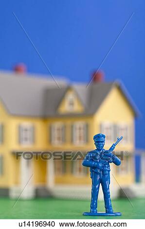 Figurine of soldier in front of model of house View Large Photo Image Stock Image - Figurine of soldier in front of model of house. Fotosearch