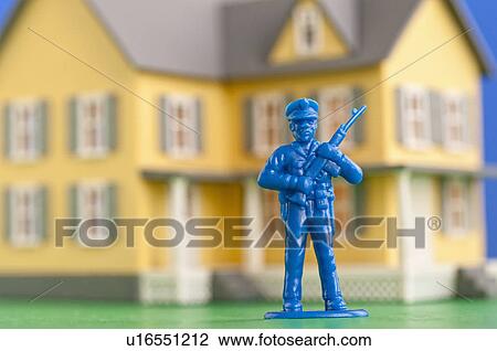 Figurine of soldier in front of model of house View Large Photo Image Stock Image - Figurine of soldier in front of model of house. Fotosearch