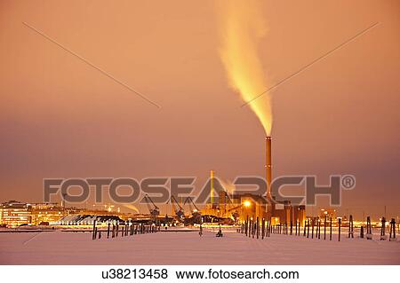 Stock Photo - Finland, Helsinki, Smoking chimney in dock. Fotosearch