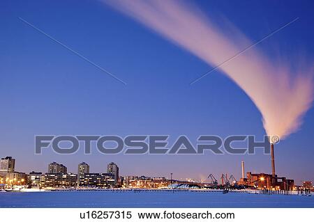 Stock Photography - Finland, Helsinki, Smoking chimney in dock. Fotosearch