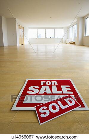 Stock Photo - For sale sign in empty room. Fotosearch