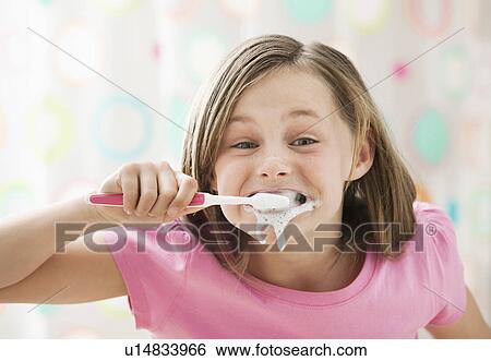 Girl (10-11) brushing teeth in messy way View Large Photo Image Stock Photograph - Girl (10-11) brushing teeth in messy way. Fotosearch