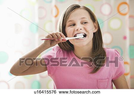 Stock Photograph - Girl (10-11) brushing teeth. Fotosearch