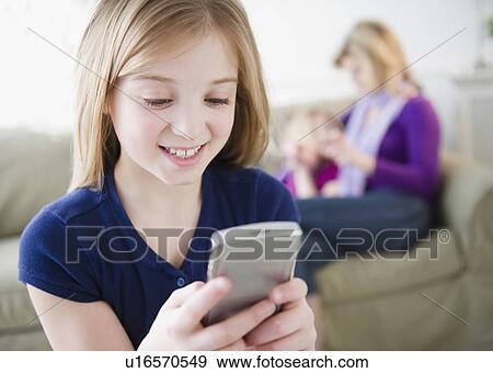 Girl (10-11) holding remote control View Large Photo Image Stock Photo - Girl (10-11) holding remote control. Fotosearch