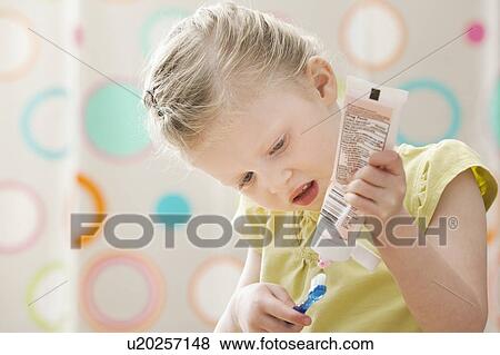 Stock Photo - Girl (2-3) brushing teeth. Fotosearch