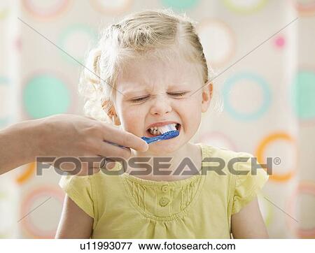 Stock Photo - Girl (2-3) having teeth brushed. Fotosearch