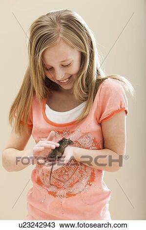 Stock Image - Girl (8-9) playing with mouse. Fotosearch