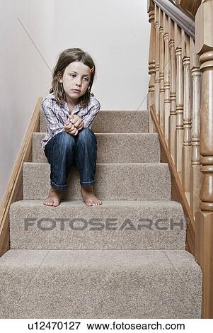 Girl (8-9) sitting on stairs View Large Photo Image Stock Photo - Girl (8-9) sitting on stairs. Fotosearch