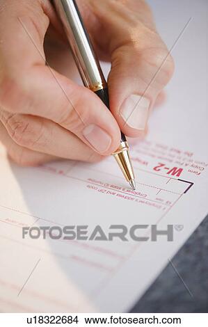 Hand filling tax form View Large Photo Image Picture - Hand filling tax form. Fotosearch