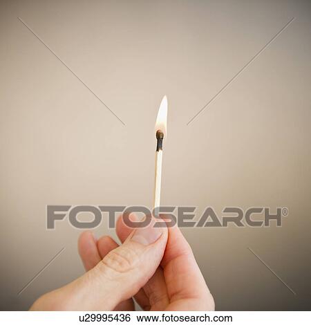 Stock Photograph - Hand holding match. Fotosearch
