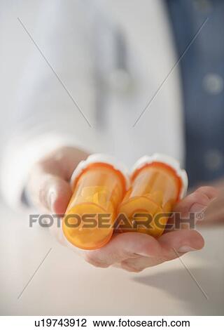 Hand holding pill bottles View Large Photo Image Stock Image - Hand holding pill bottles. Fotosearch