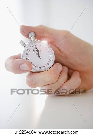 Hand holding stopwatch View Large Photo Image Picture - Hand holding stopwatch. Fotosearch