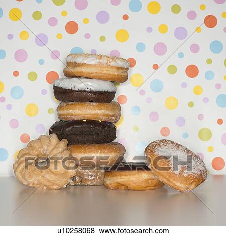 Stock Photo - Heap of doughnuts with spotted background. Fotosearch