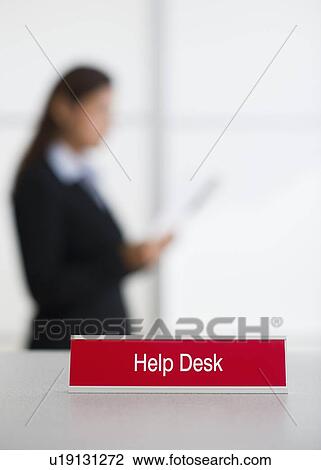 Help Desk Sign With Defocused Woman In Background Stock Image