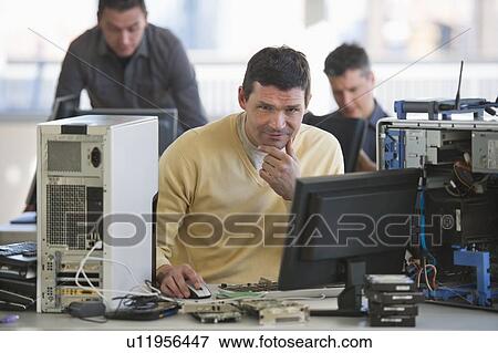 IT Professionals repairing computer in office View Large Photo Image Stock Photo - IT Professionals repairing computer in office. Fotosearch