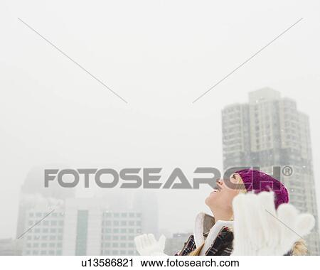 Stock Image - Jersey City, New Jersey, woman looking at bright sky. Fotosearch