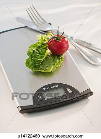 Lettuce and tomato on weight scale View Large Photo Image Stock Image - Lettuce and tomato on weight scale. Fotosearch
