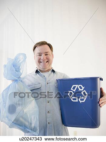 Man holding bag and recycling bin View Large Photo Image Stock Image - Man holding bag and recycling bin. Fotosearch