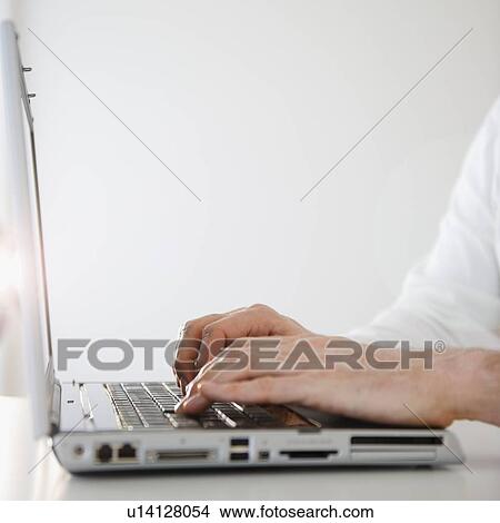Man using laptop, close-up of hands View Large Photo Image Picture - Man using laptop, close-up of hands. Fotosearch