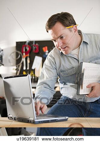 Man using laptop View Large Photo Image Stock Image - Man using laptop. Fotosearch