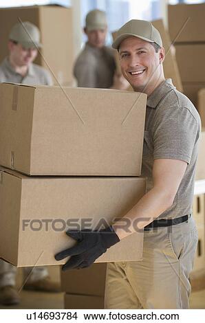 Picture - Men sorting boxes in warehouse. Fotosearch